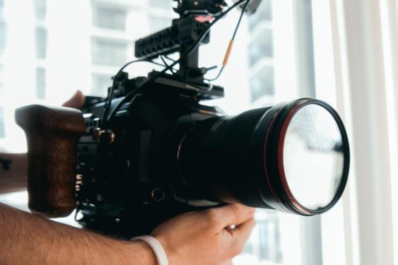 Person Holding Black DSLR Camera