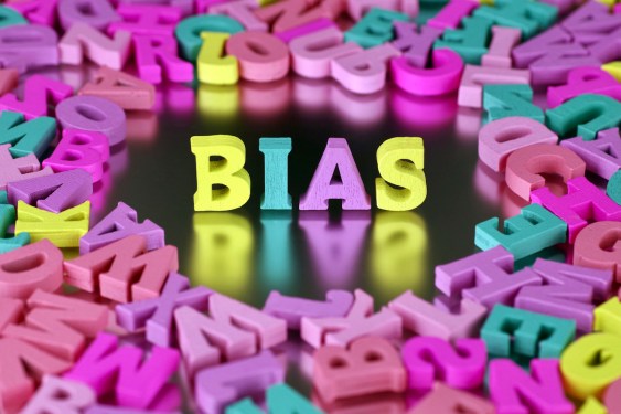 Colorful wooden craft letters spelling out the word “bias”