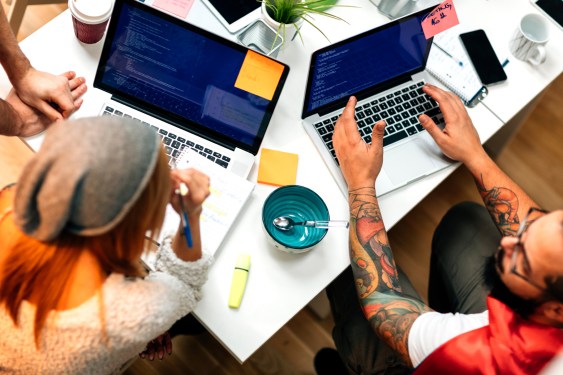 Two people at laptops, coding