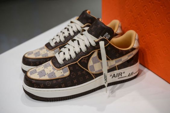 A pair of Louis Vuitton-Nike sneakers is displayed at Sotheby's in New York on January 19, 2022. - Two months after the death of US designer Virgil Abloh a pair of Louis Vuitton-Nike sneakers, designed for the last fashion show during his lifetime in 2021 and awaited by collectors, will be auctioned at a minimum of 2,000 USD for the benefit of a charity, Sotheby's announced. (Photo by Ed JONES / AFP) (Photo by ED JONES/AFP via Getty Images)