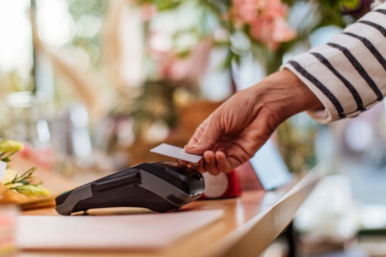 A person making a contactless credit card payment