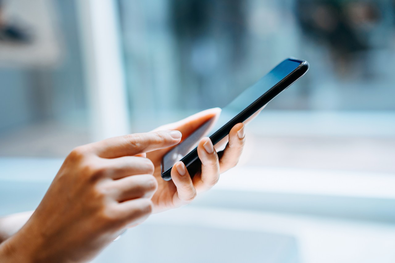 Close up of young woman using smartphone