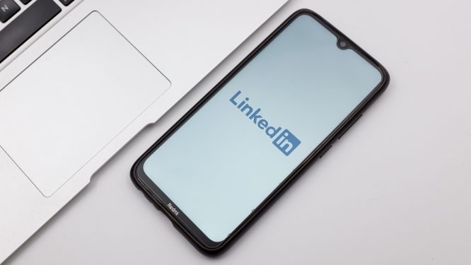 LinkedIn mobile app displayed on smartphone set on desk