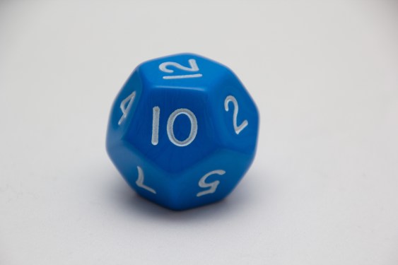 Single Large blue twelve sided dice showing 12, on white background