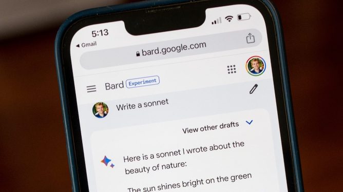 Person's hand holding an iPhone using the Google Bard chatbot