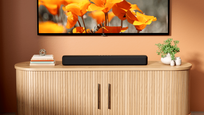 Fire TV Soundbar under a wall-mounted TV