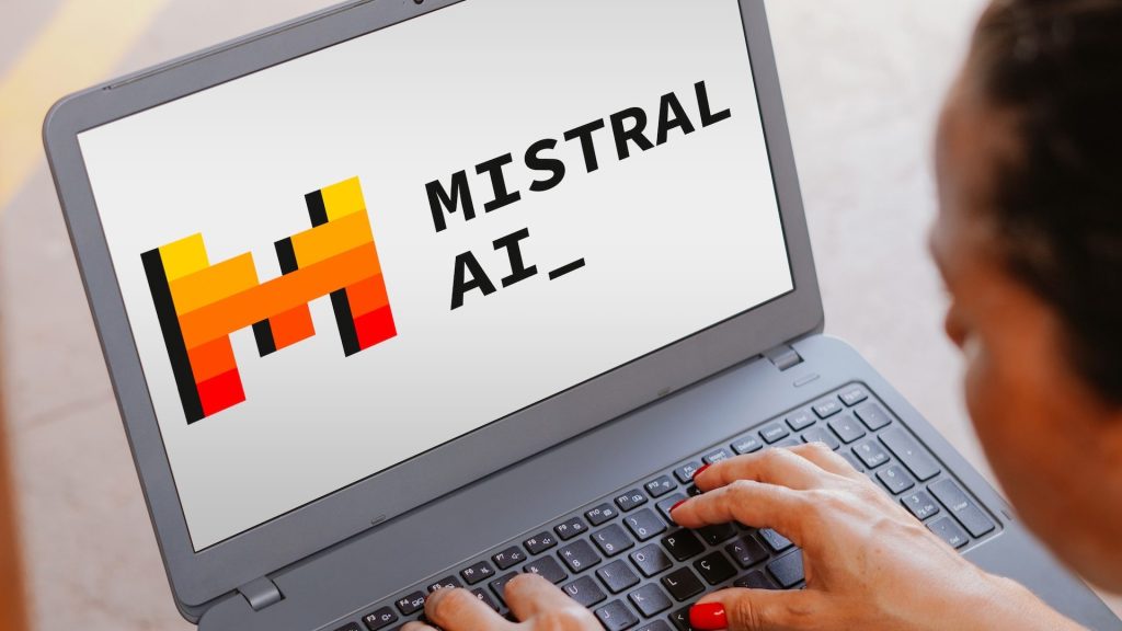 The Mistral AI logo is seen displayed on a laptop screen.