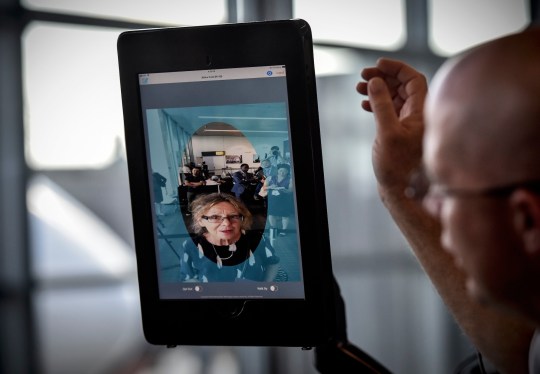 a facial recognition tablet used at Dulles Airport featuring someone's face