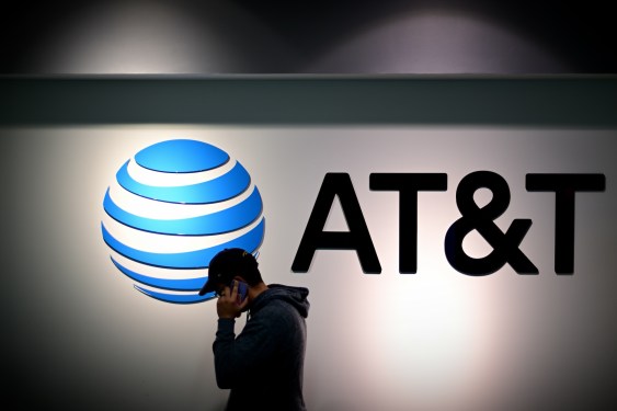 a shopper walks past an AT&T sign outside a store in PA.