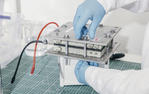 A lab technician seen close up working on a carbon dioxide removal device.