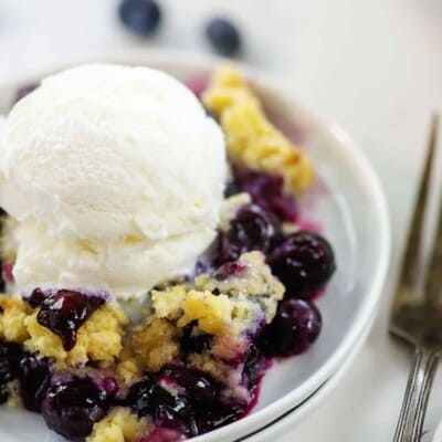 blueberry cobbler on small white plate.