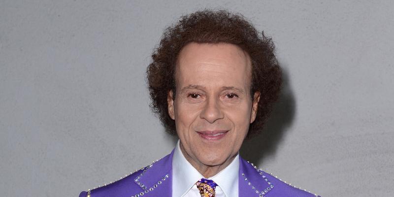 Richard Simmons wearing a purple suit