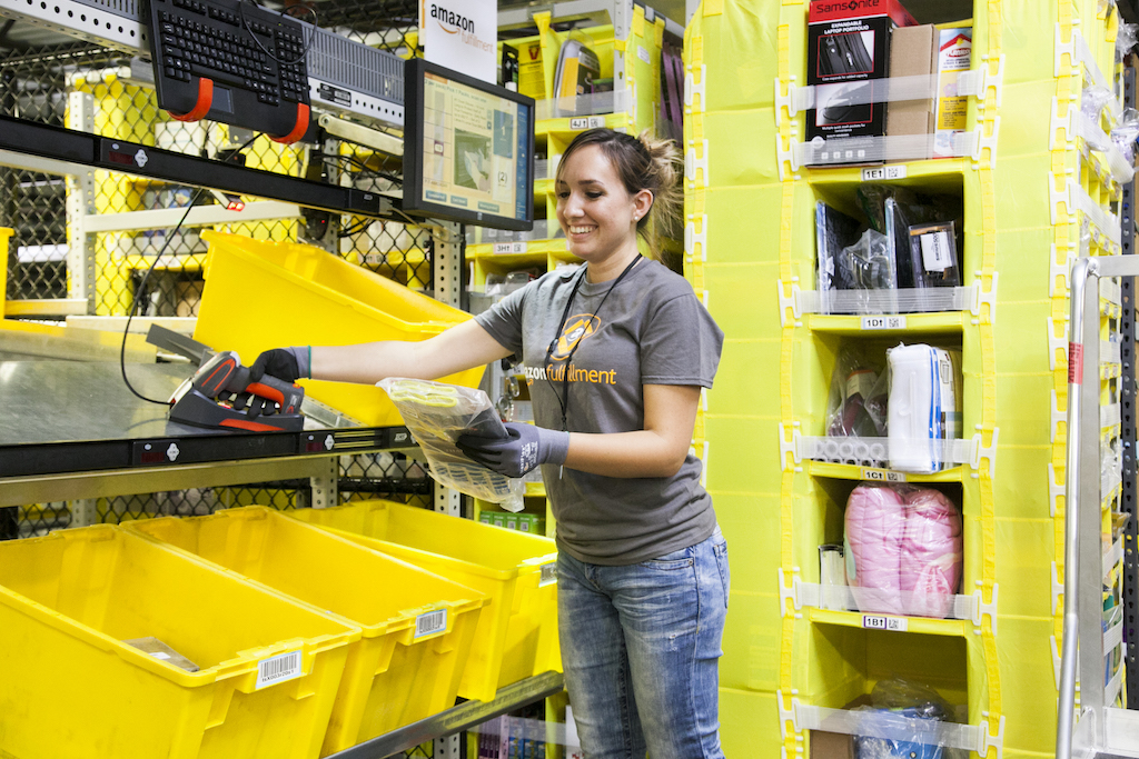 An employee picks products at an Amazon fulfillment center