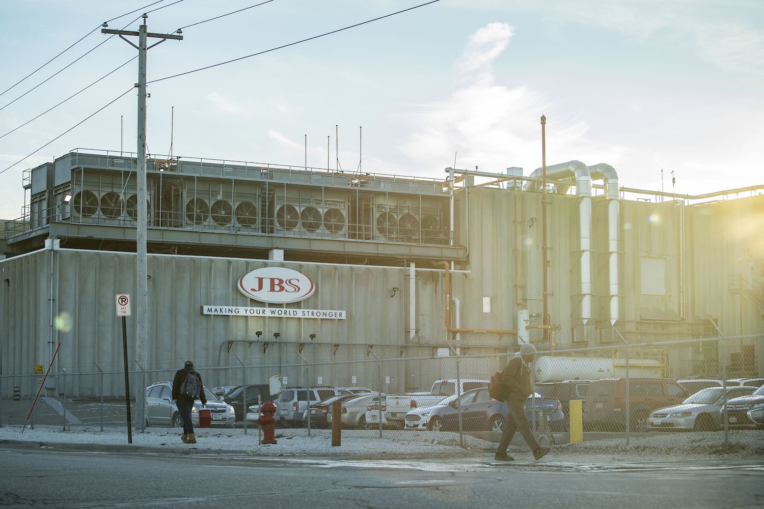 Employees walk past the JBS plant in Marshalltown, Iowa on Wednesday, December 5, 2018.