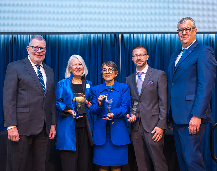 President Kaler and Vice President Michael Oakes pose with this year&#039;s Faculty Distinguished Research Award winners.