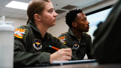 Second Lt. Victoria Cutt and 2nd Lt. Marques Johnson, University of North Dakota Aerospace Foundation student pilots, listen to their instructor, Jan. 7, 2025, in Mesa, Ariz.