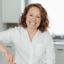 Headshot of Beth holding spoon and mixing ingredients in a bowl.