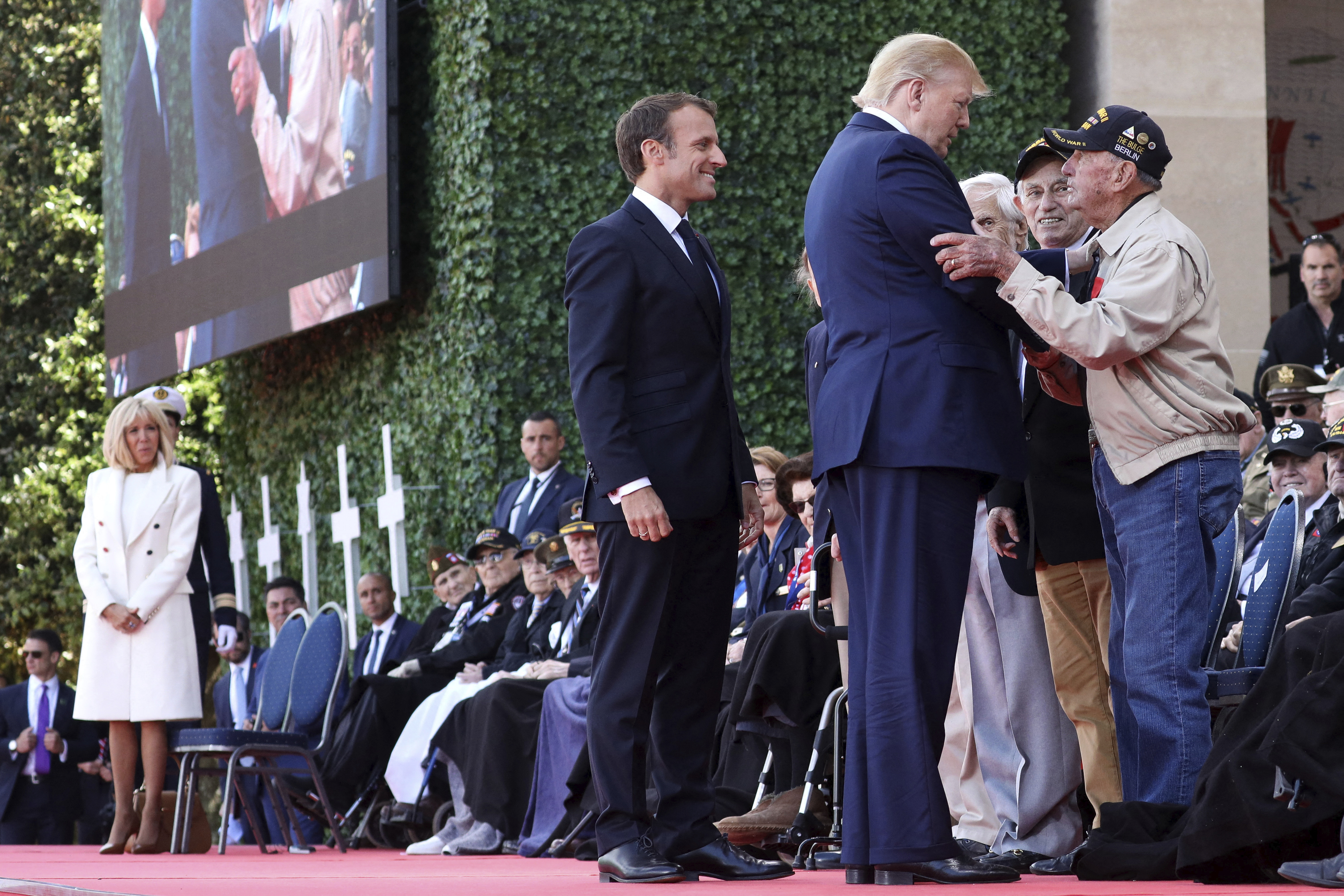 File photo dated June 6, 2019 of U.S. President Donald Trump and French President Emmanuel Macron speak to veterans during a ceremony commemorating the 75th anniversary of the D-Day, at Normandy American Cemetery and Memorial situated above Omaha Beach, in Colleville-sur-Mer, France. President Trump refused to visit a First World War cemetery in France because he said dead US soldiers were "losers" and "suckers". The allegations, first reported in The Atlantic, contain multiple instances of Mr Trump making disparaging remarks about members of the US military who have been captured or killed, and claim that the president refused to attend a service at the Aisne-Marne American Cemetery in France in 2018. Mr Trump said on Thursday that the story is "totally false." Photo by Stephane Lemouton/pool/Abaca/Sipa USA(Sipa via AP Images)