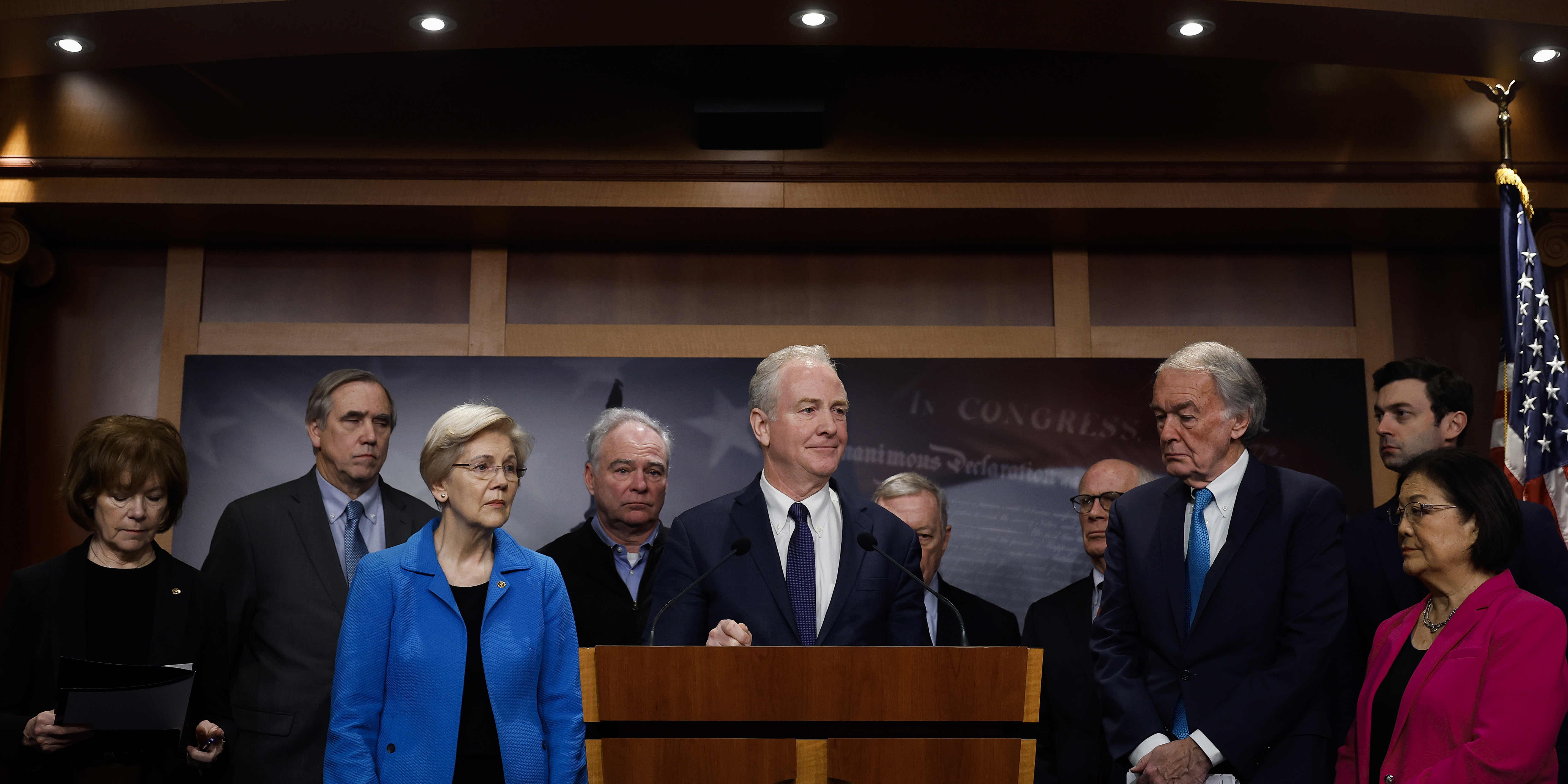 WASHINGTON, DC - FEBRUARY 09: Sen. Chris Van Hollen (D-MD), talks to reporters with (L-R) Sen. Tina Smith (D-MN), Sen. Jeff Merkley (D-OR), Sen. Elizabeth Warren (D-MA), Sen. Tim Kaine (D-VA), Senate Minority Whip Richard Durbin (D-IL), Sen. Peter Welch (D-VT), Sen. Edward Markey (D-MA), Sen. Jon Ossoff (D-GA) and Sen. Mazie Hirono (D-HI) during a news conference at the U.S. Capitol to celebrate a new policy that demands recipients of foreign military aid adhere to international humanitarian law on February 09, 2024 in Washington, DC. President Joe Biden signed the national security memorandum Thursday after it became clear that an amendment codifying the accountability policy would not be attached to a new spending supplemental for military aid being sent to Ukraine, Israel and other allies. (Photo by Chip Somodevilla/Getty Images)