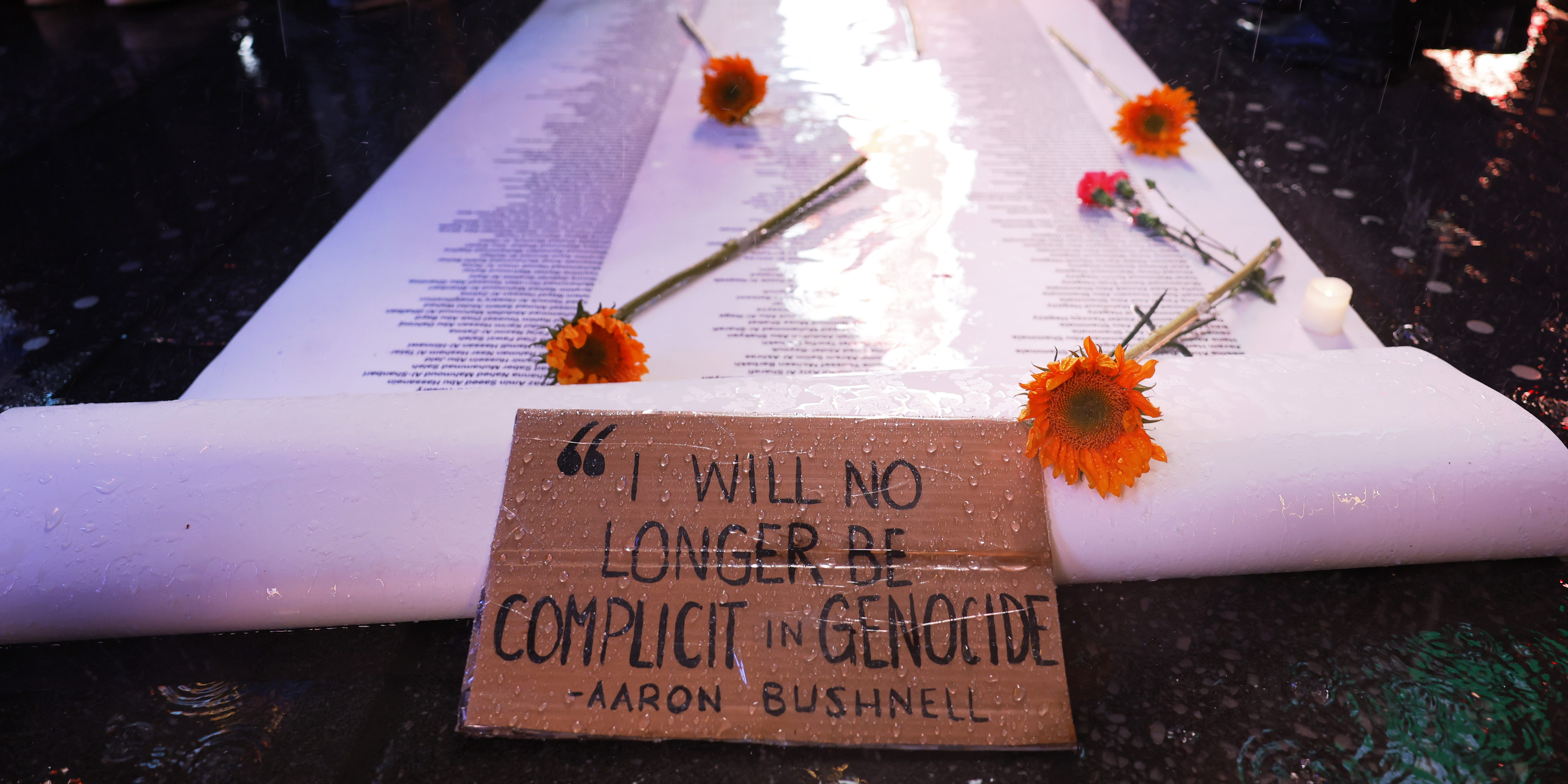 NEW YORK, NEW YORK - FEBRUARY 27: A sign with words one of the last words said by U.S. Airman Aaron Bushnell is seen during a vigil at the US Army Recruiting Office in Times on February 27, 2024 in New York City. Bushnell died after setting himself on fire outside the Israeli Embassy in Washington, DC on Sunday. In a video that was posted to a social media account showing the act, he stated that would “no longer be complicit in genocide," before pouring an unknown liquid over himself and igniting it while yelling “Free Palestine” repeatedly. (Photo by Michael M. Santiago/Getty Images)