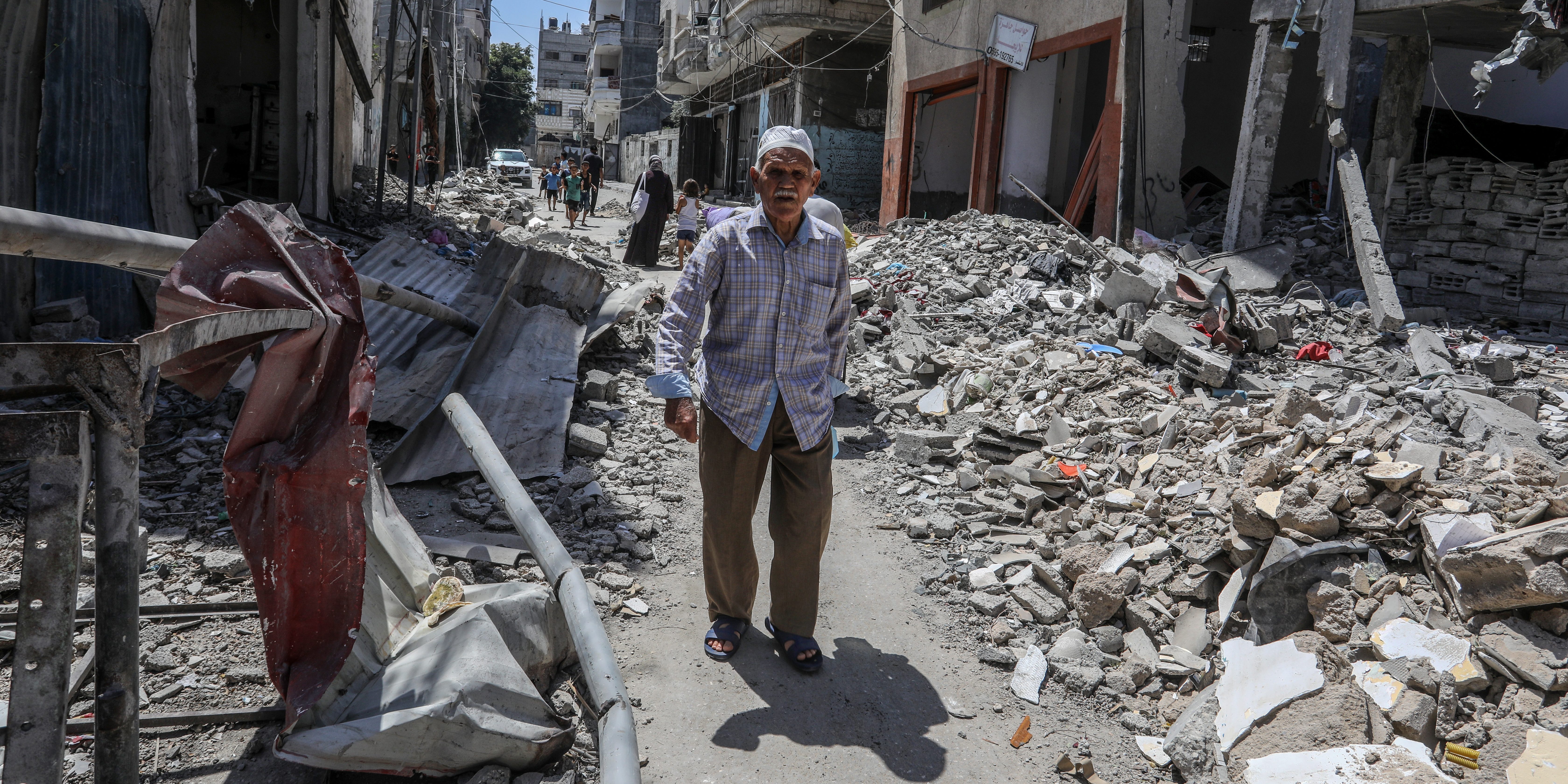 GAZA CITY, GAZA - JUNE 12: Palestinian kids walk among the debris of buildings collapsed by Israeli attacks after the withdrawal of the Israeli army from the Bureij refugee camp in Gaza City, Gaza on June 12, 2024. After the withdrawal of the Israeli army, the great destruction and devastation in the area was revealed. (Photo by Abed Rahim Khatib/Anadolu via Getty Images)