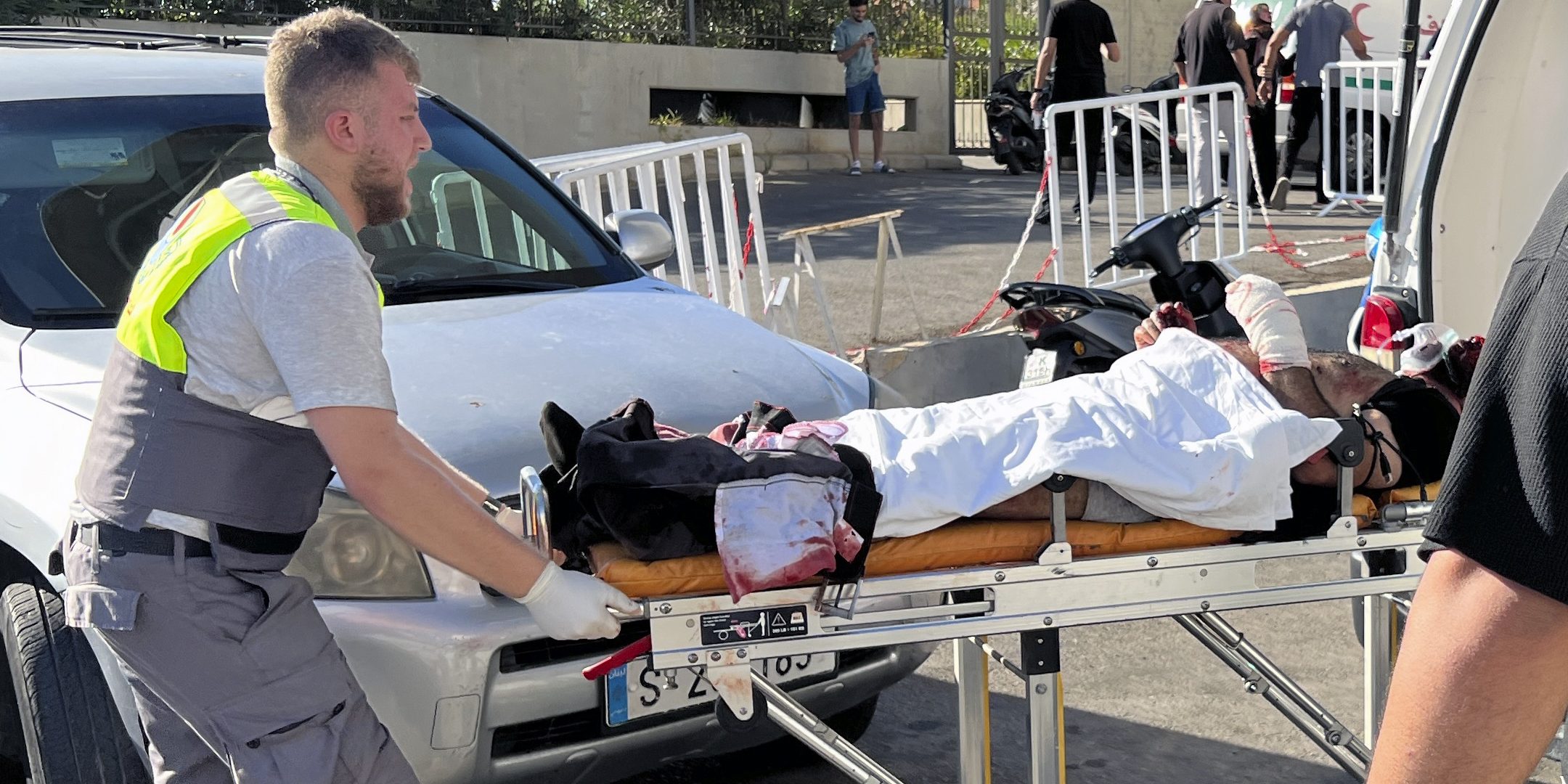 A first-responder carries a wounded man whose handheld pager exploded at al-Zahraa hospital in Beirut, Lebanon, Tuesday, Sept. 17, 2024.