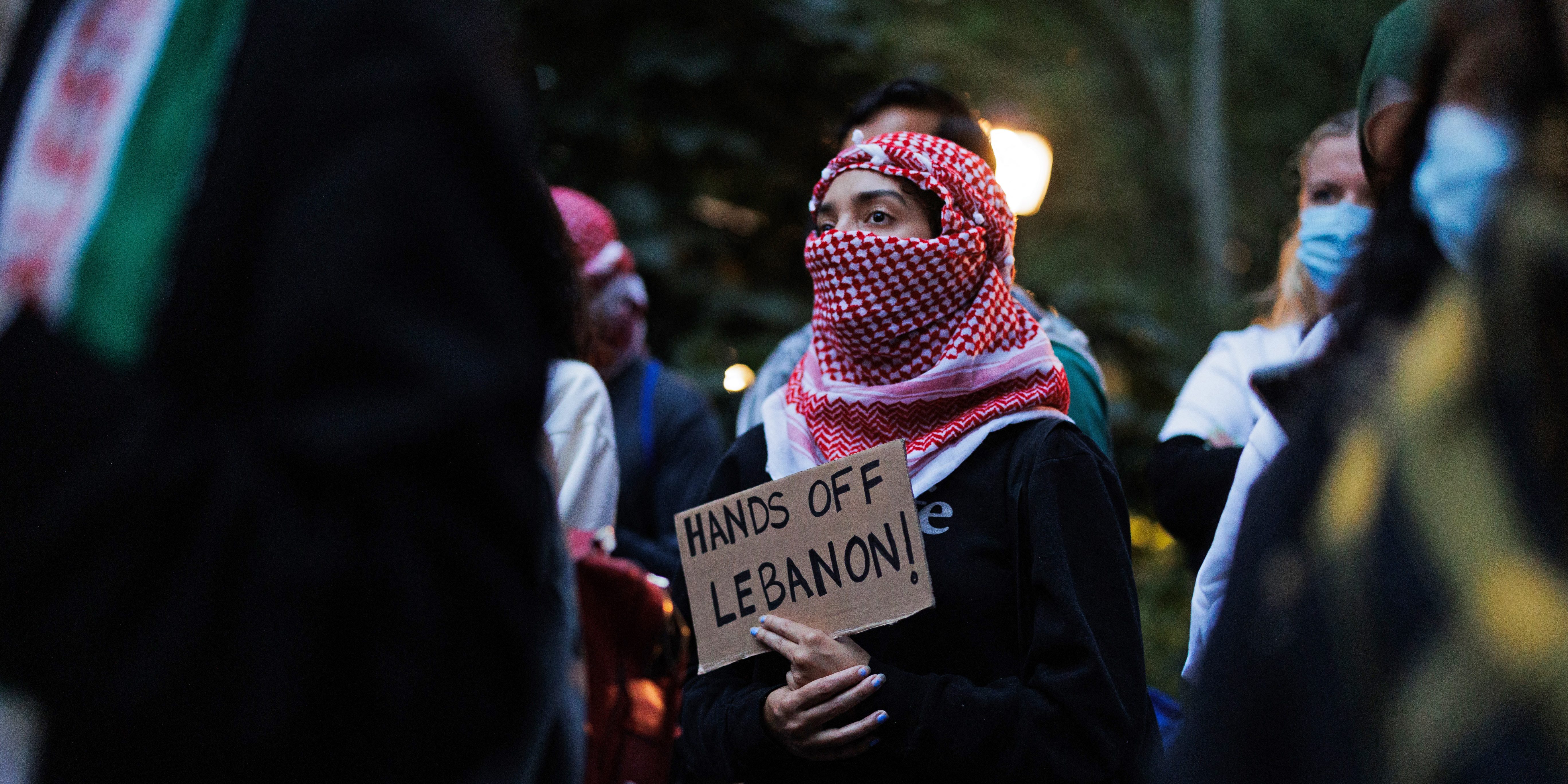 TOPSHOT - People participate in a "Flood Manhattan for Lebanon" protest with signs at Madison Square Park in New York on September 24, 2024. Tens of thousands of people have fled their homes in Lebanon as Israeli strikes pummelled the country, the UN said September 24, calling events "extremely alarming." Israeli air strikes killed at least 558 people on September 23, including 50 children and 94 women, according to Lebanon's health ministry. (Photo by Paul FRANGIPANE / AFP) (Photo by PAUL FRANGIPANE/AFP via Getty Images)