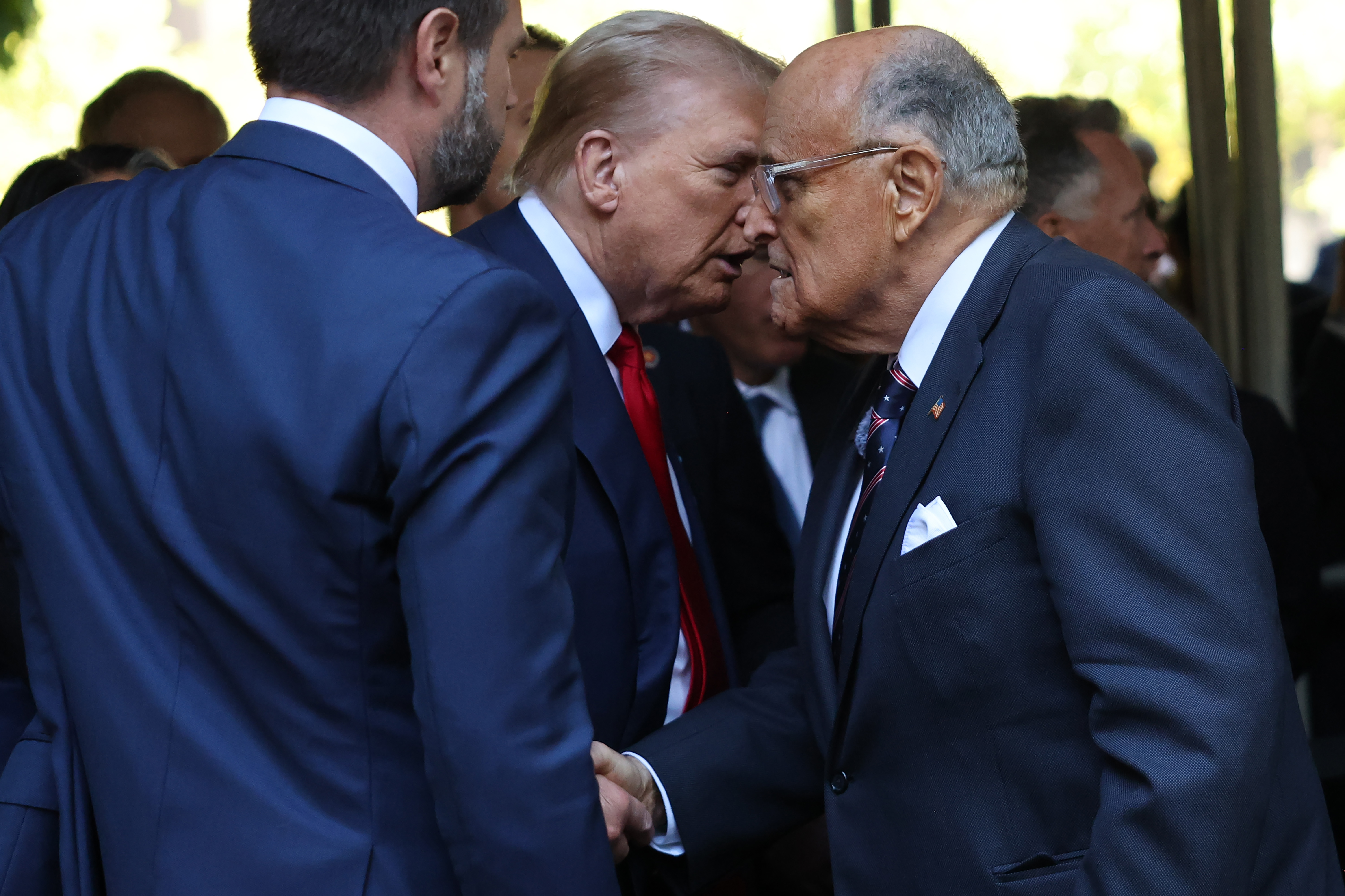 Former U.S. President Donald Trump and former NYC Mayor Rudy Giuliani shake hands as they attend the annual 9/11 Commemoration Ceremony at the National 9/11 Memorial and Museum on September 11, 2024 in New York City.