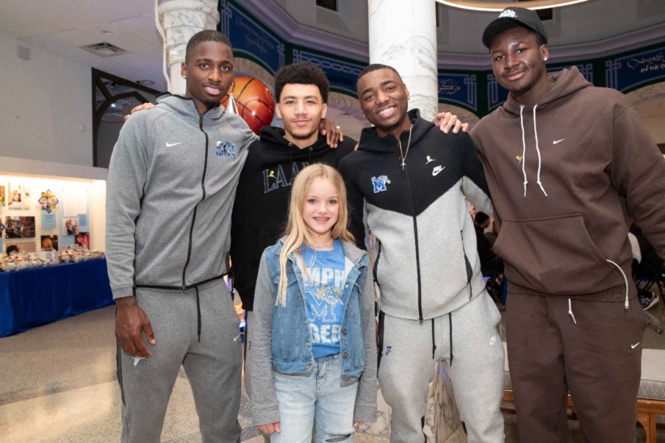 <strong>From left, 2023-24 Memphis Tigers David Jones, Jahvon Quinerly, Jayhlon Young and Carl Cherenfant visit with Mabry (front), who survived an acute lymphoblastic leukemia (ALL) diagnosis, on Dec. 20, 2023, at St. Jude Children&rsquo;s Research Hospital.</strong> (Courtesy Nikki Boertman)