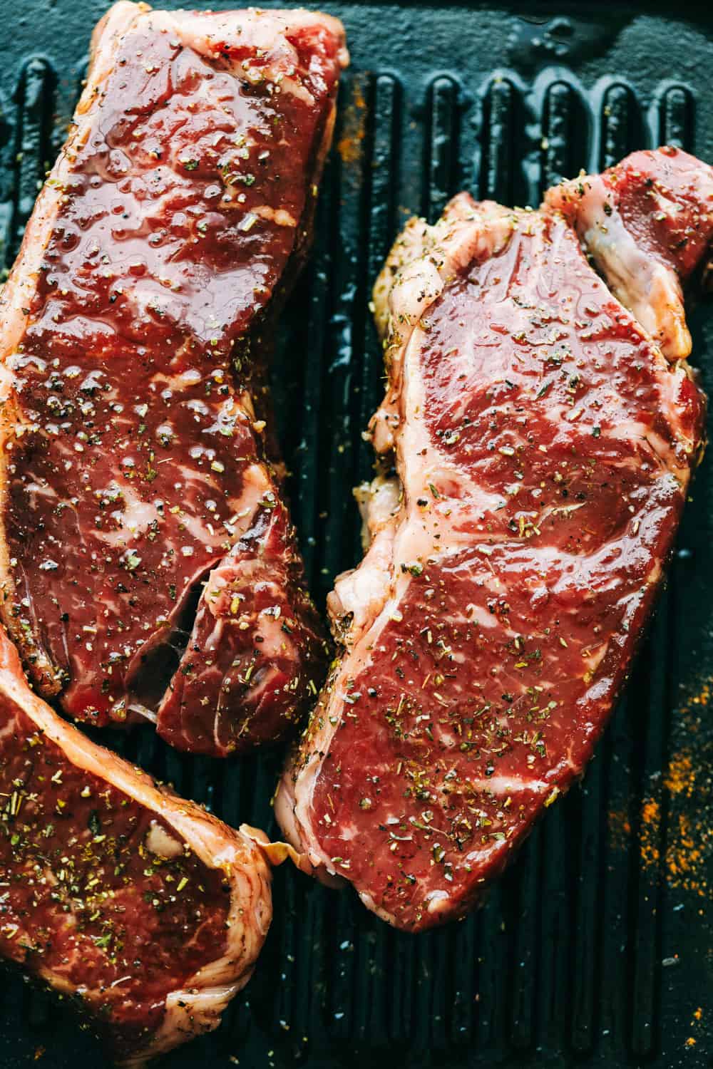 Steak cooking on a grill pan.