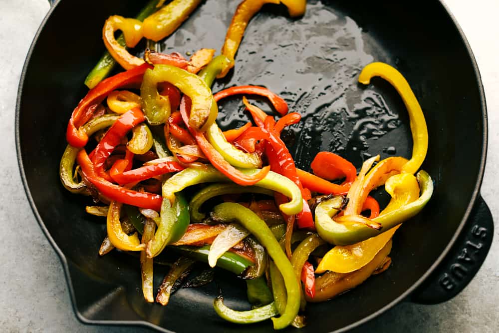 bell peppers sautéing in a skillet