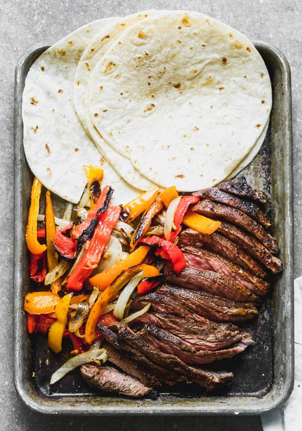 Steak fajitas on a sheet pan. 