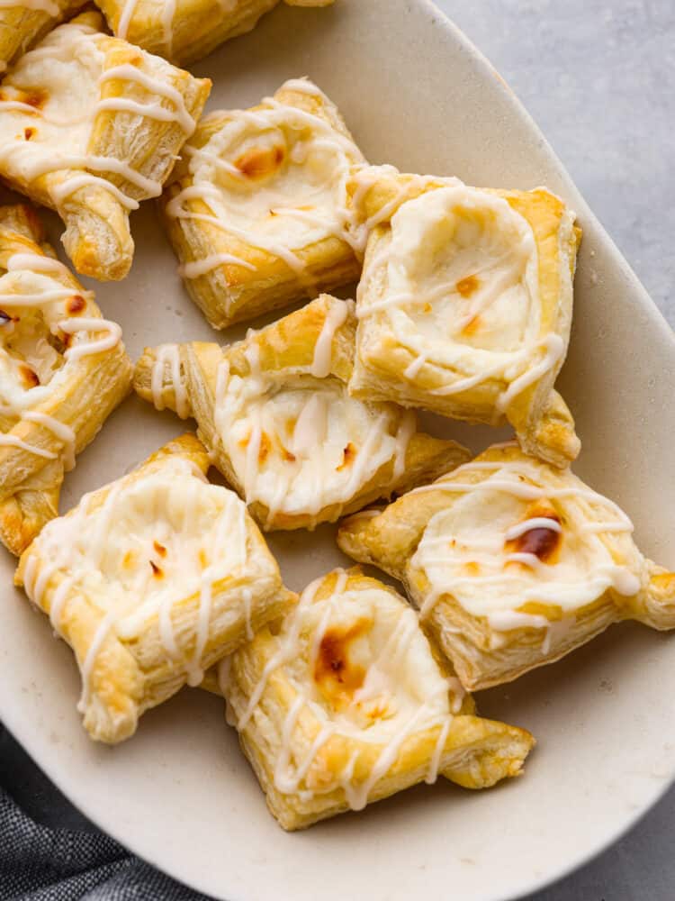 Top-down view of cream cheese danishes on a white plate.