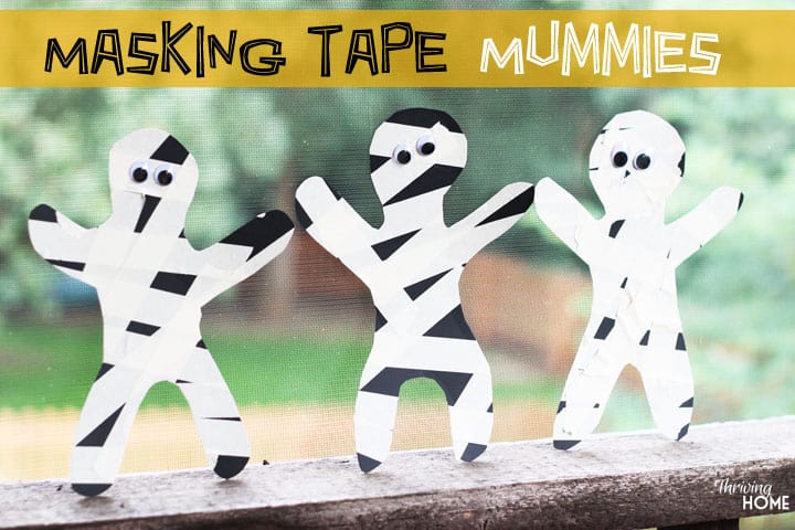 Masking tape mummy craft - people shaped cutouts from black construction paper with masking tape on them to make them look like mummies with googly eyes added.