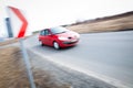 Car driving fast through a sharp turn