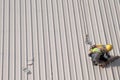 Construction worker marking roof