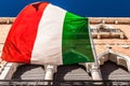 VENICE, ITALY - AUGUST 20, 2016: Italian flag and facades of old medieval buildings close-up on August 20, 2016 in Venice, Italy