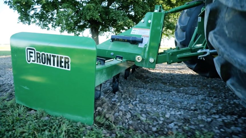 Repairing a gravel drive using a box blade with scarifiers.