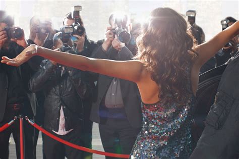 Celebrity Posing For Paparazzi On Red Carpet Stock Photo Download