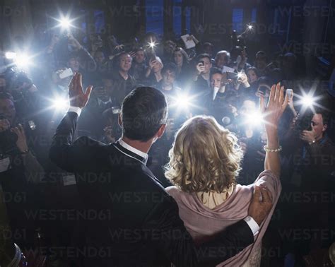 Celebrity Couple Waving To Paparazzi At Red Carpet Event Stock Photo