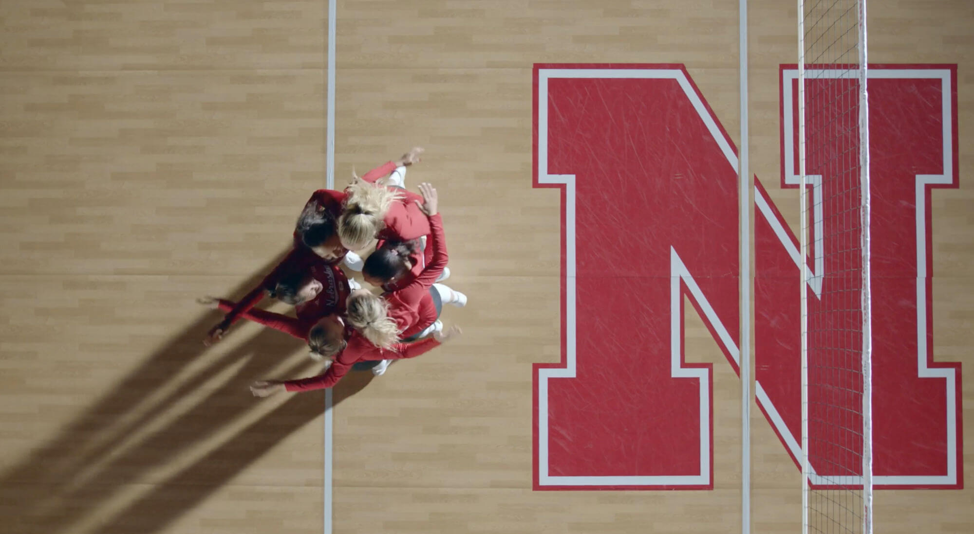 Overheard shot of volleyball players celebrating on court