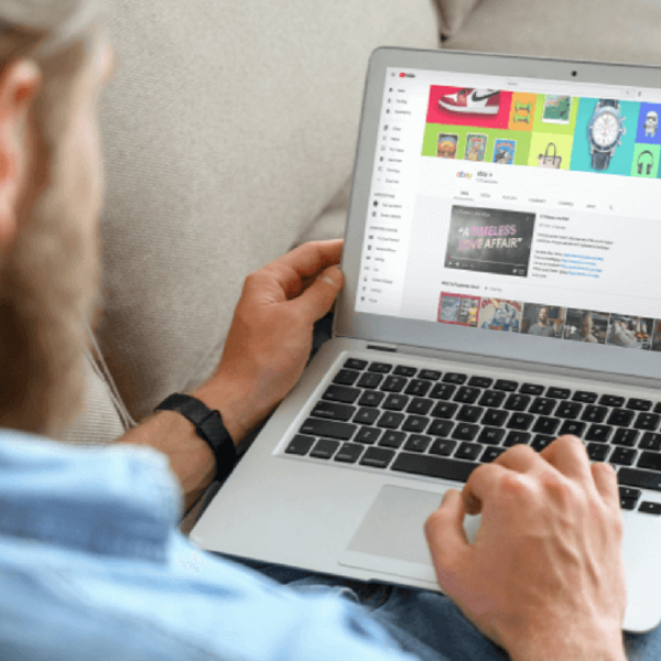 Man using laptop and YouTube is on-screen