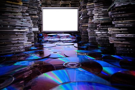 Hundreds of CDs and CD cases, illuminated by a white screen.