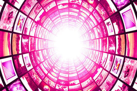 A tunnel of bright pink screens with bright light at the end.