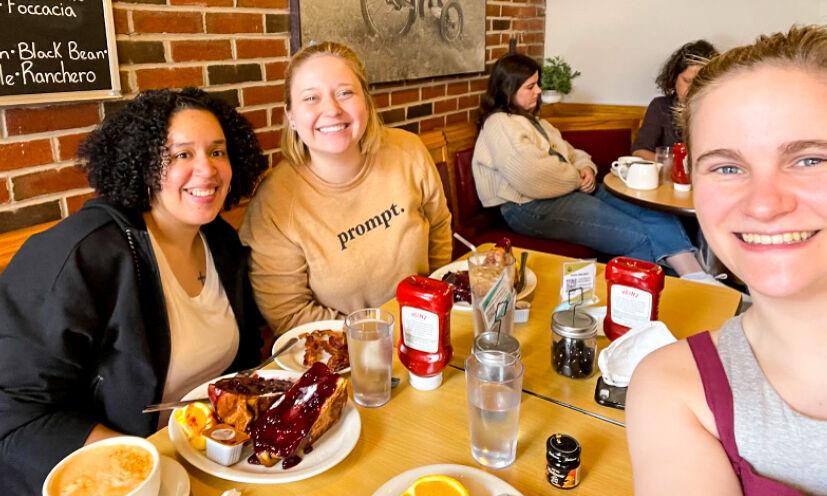 Cristina Miranda, Emily Huckins, and Lucy Camarata (L-R) sit for lunch in Trident Booksellers &amp; Cafe in Boston on March 15, 2022.