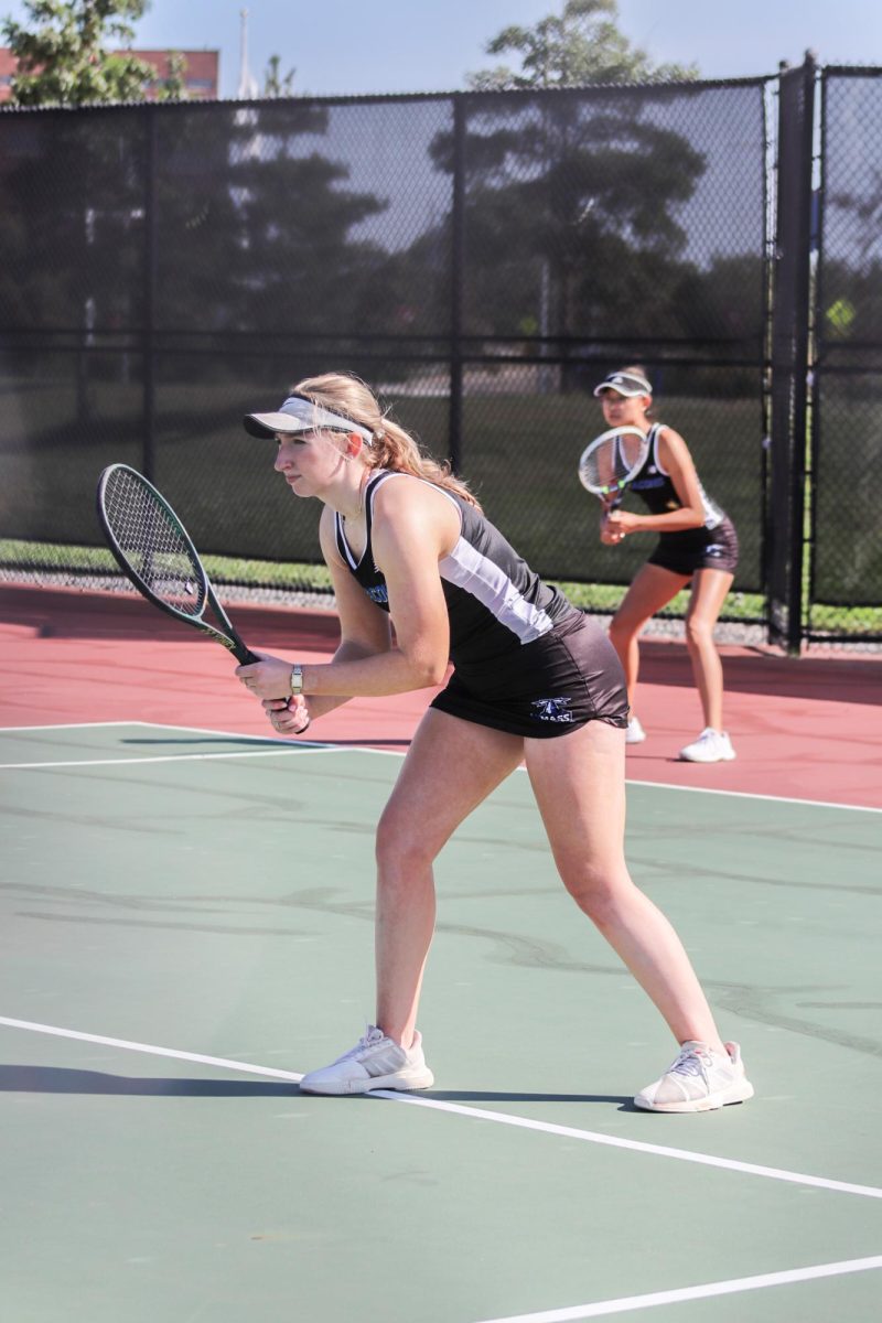 Women’s tennis players brace themselves for a home match last September. 