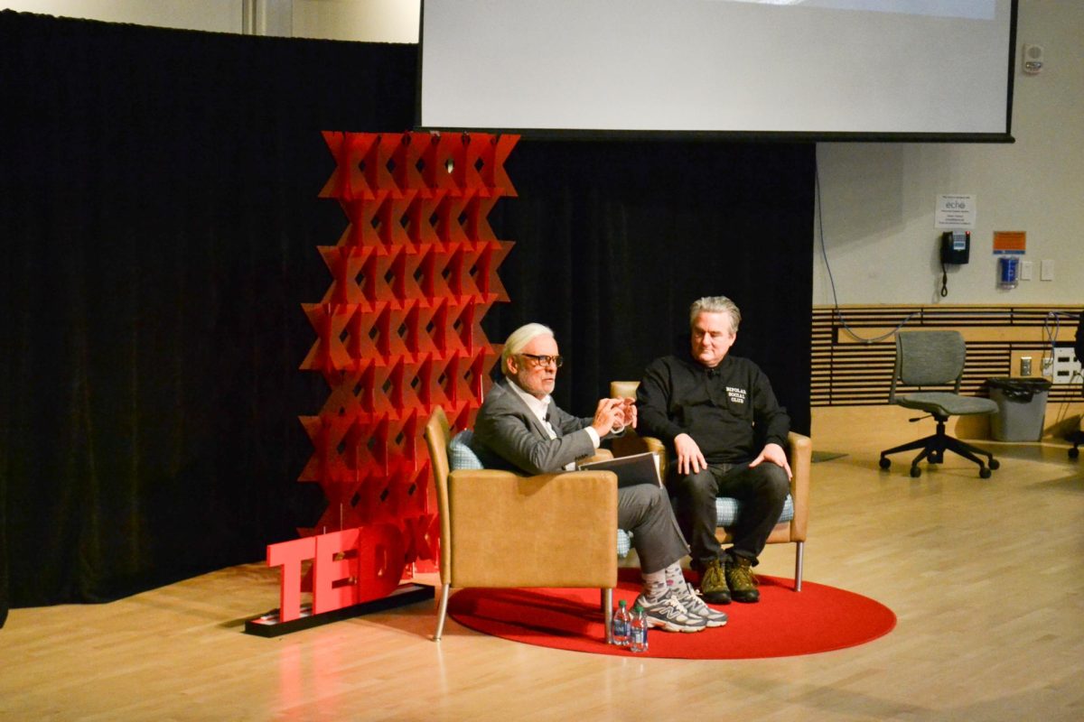 Chancellor Marcelo Suárez-Orozco and UMass Boston alum and entrepreneur Paul English chat on stage during the TEDx Boston at UMass Boston. Photo submitted by Valentina Valderrama Pérez / Mass Media Staff.