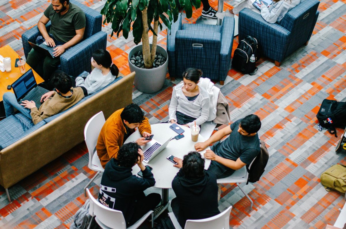 Students relax and do work together in the Campus Center as the semester winds down. Photo by Saichand Chowdary / Mass Media Staff