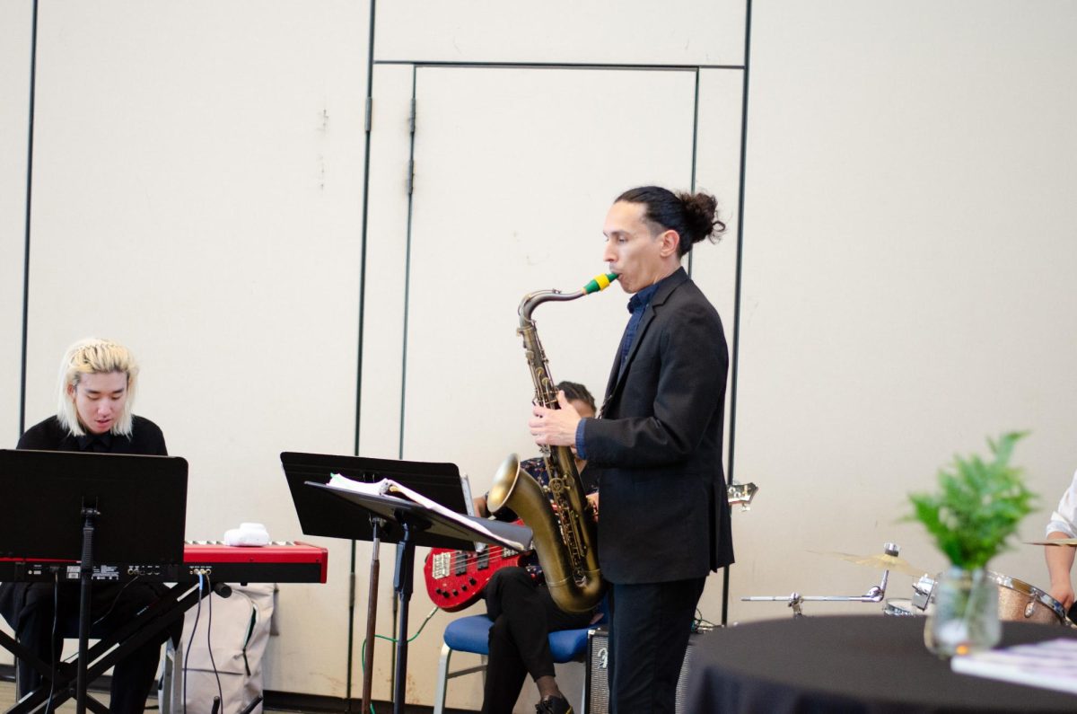 A musician playing the saxophone at a live performance.