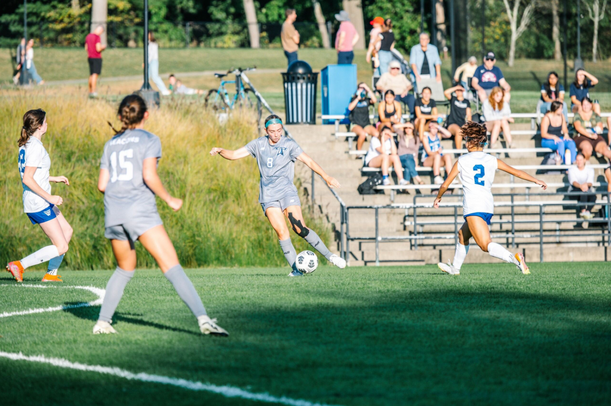 Georgia Bonney, Number 8, passing the ball to her teammates.